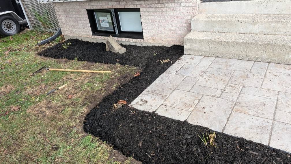 Parterres paillés près d'une entrée de maison.